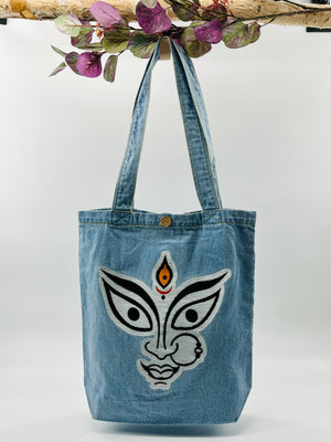 The face of "MAA KALI / Durga" Denim Tote Bag | Light Blue Denim
