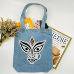 The face of "MAA KALI / Durga" Denim Tote Bag | Light Blue Denim